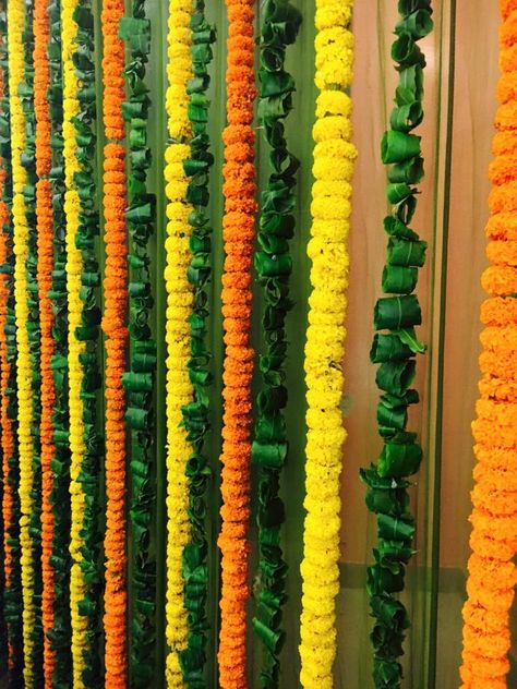 Fresh strings of #marigold and #green #leaves are a sight to behold! #Love this. What do you think? #wedding #picoftheday #bridetobe #weddinghour #happy #lucky #blessed #WedLongAndProsper #groom #family #beautiful #fun #smile #follow #perfect #event #love #marriage #wedding #cute #happiness #happy #follow Ashok Leaves Decoration, Marigold Wedding Decoration, Chath Puja, Indian Floral Decor, Flower Toran, Leaf Decor Wedding, Marigold Wedding, Coaster Diy, Orange Marigold