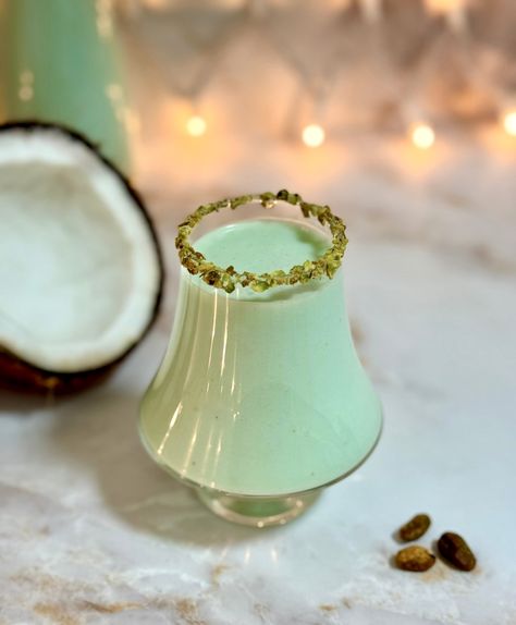 Coquito de pistachio is a creamy holiday drink made with coconut milk, pistachio ice cream, and rum. It is served chilled and is absolutely delicious. Along with a plate of arroz con gandules, pernil and pasteles, Puerto Rican coquito is a staple during the holidays! If you love coquito and the taste of pistachios, save this recipe. This pistachio version does not disappoint! Pistachio Coquito Recipe, Nutella Coquito Recipe, Puerto Rico Coquito Recipe, Pistachio Coquito, Traditional Coquito Recipe, How To Make Coquito, Coconut Eggnog, Puerto Rican Food, Coquito Recipe