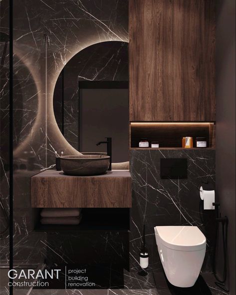 This bathroom is made in dark colors with combination of marble textures and wood. The result is stylish and bold👌 The mirror with LED creates a special atmosphere✨ Garant Construction – we create interiors of your dream!♥️ Antracit Bathroom Ideas, Modern Dark Bathroom, Dark Marble Bathroom, Dark Bathroom Design, Modern Powder Room Design, Small Dark Bathroom, Modern Powder Room, Dark Bathroom, Dark Wood Bathroom