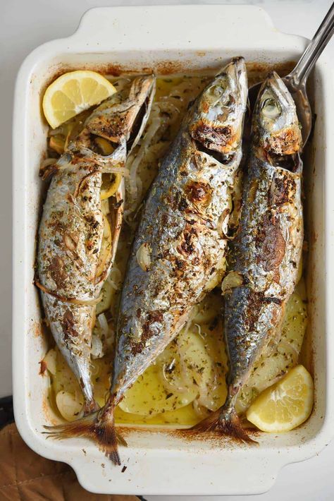 Baked Mackerel With Potatoes And Onions is a super simple and effortless meal. With all the good Greek-style flavors of lemon, oregano, and garlic. + plenty of mellow onions. Baked Mackerel, Fish Masala, Sea Food Dishes, Grilled Mackerel, Mackerel Recipes, Crushed Potatoes, Potatoes And Onions, Mackerel Fish, Potato Slices