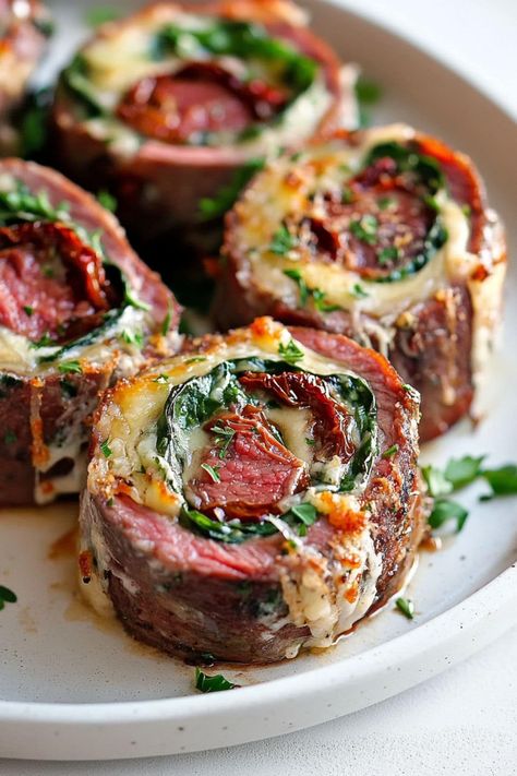 Looking for something fancy? Try these incredible steak pinwheels! With spinach, sun-dried tomatoes, and cheese, they're a feast for the senses. Steak Pinwheel Recipes, Beef Dishes For A Crowd, Rolled Flank Steak, Beef Pinwheels, Flank Steak Pinwheels, Flank Steak Rolls, Steak Roll Ups, Steak Pinwheels, Tomatoes And Cheese