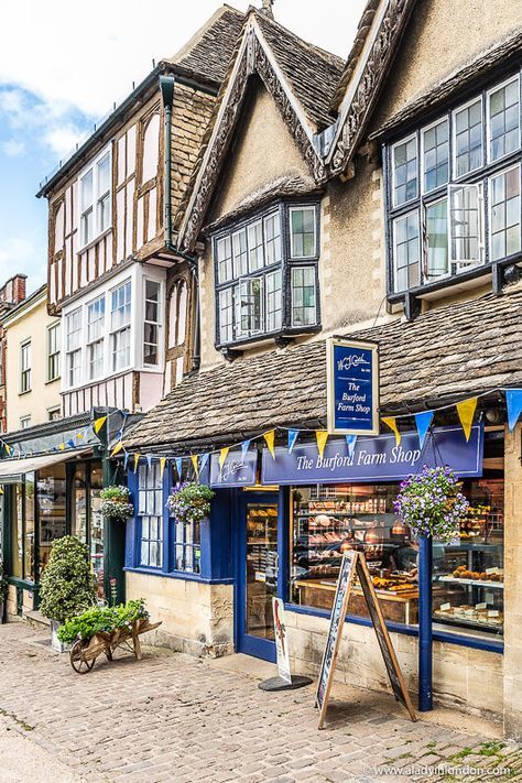 Shops on the high street in Burford, a pretty village in the Cotswolds, England. Click through for more pictures on the A Lady in London blog. #burford #cotswolds #england Cotswolds Cottage, Cotswolds England, English Village, Voyage Europe, Waffle Knit Sweater, England And Scotland, The Cotswolds, England Uk, English Countryside