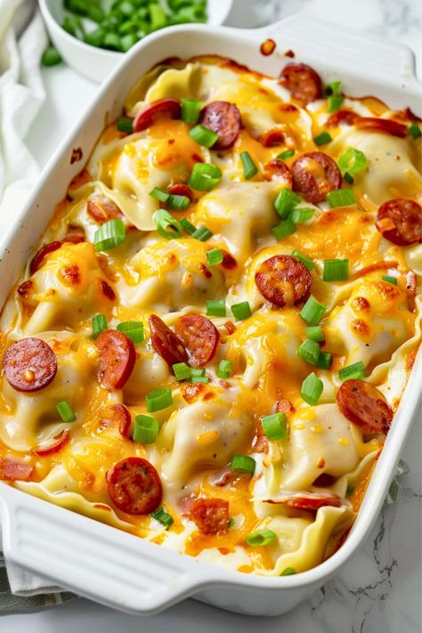 Get ready to indulge in the ultimate comfort food with this pierogi casserole! It's creamy, cheesy, satisfying, and downright delicious. Keilbasa And Perogies Recipes Easy, Cheesy Supper Ideas, Polish Sausage And Perogies, Perogies And Sausage Casseroles, Perogie Casserole Kielbasa, Dinner With Perogies, Baked Perogies Casserole, Perogies Dishes, Fast Easy Meals Dinners