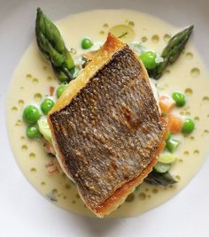 The firm flesh of bream in Nathan Outlaw's recipe is complemented by the sweet flavour of cream-enriched tartare-style sauce flecked with potatoes, asparagus, lettuce and peas. You can buy two large, whole fish if you want to fillet them yourself, or ask your fishmonger to do this for you. Asparagus And Peas, Tarragon Sauce, Black Cod, Great British Chefs, Fine Dining Recipes, Easy Slow Cooker Recipes, White Plate, Great British, Fish Dishes