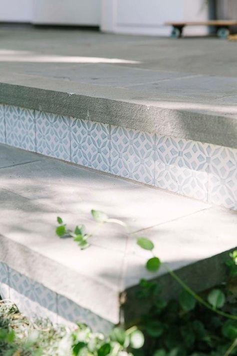 Concrete steps leading to a front porch are accented with blue mosaic tiles. Front Porch Step, Front Porch Remodel, Front Porch Steps, Front Door Steps, Front Stairs, Tile Steps, Blue Mosaic Tile, Front Porch Makeover, Porch Tile