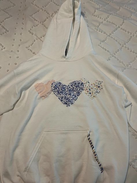 Heart Sewn Hoodie | This sweatshirt comes with multiple, customizable colors and fabrics and is sewn by hand. Because each sweatshirt is handmade, no two sweatshirts are alike. Custom stitching is also chosen by designer to match fabric. Viral Heart Hoodie, Diy Hoodie Iron On Ideas, Stitch Work Hoodie, Fabric Sweatshirt Design, How Lucky Are We Sweatshirt, Embroidered Heart Sweatshirt, Hoodies With Embroidery, Heart Patch Hoodie, Making Sweatshirts With Friends