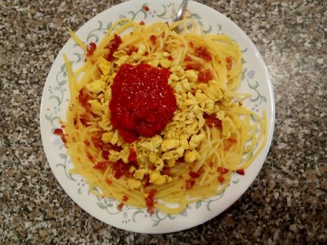 Spaghetti noodles, scrambled eggs, chopped up bacon, and tomato sauce. Egg Spaghetti, Scrambled Egg, Spaghetti Noodles, Scrambled Eggs, Tomato Sauce, Macaroni, Macaroni And Cheese, Noodles, Bacon