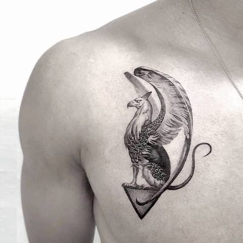 30 Inspiring Tattoos about Strength with Meaning - Our Mindful Life Small Griffin Tattoo, Gryphon Tattoo Feminine, Hypogriff Tattoo, Griffin Tattoo Men, Griffin Tattoo Feminine, Griffin Tattoo Design, Mythical Tattoos For Women, Mythical Creature Tattoo, Persian Sculpture