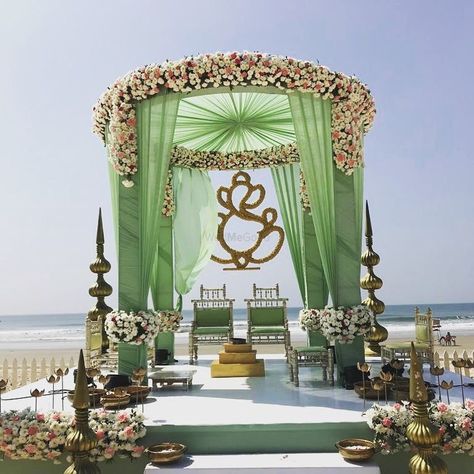 A floral mandap decor with green curtains Bengali Wedding Mandap, Indoor Mandap, Floral Mandap Decor, Mandap Decoration Ideas, Green Beach Wedding, Floral Mandap, Vidhi Mandap, Hindu Wedding Decorations, Indian Wedding Decorations Receptions