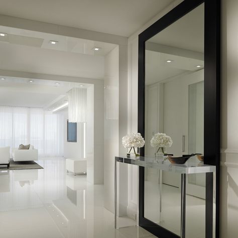 Miami is known for its vibrant culture, stunning beaches, and stunning architecture. With so many talented interior designers and professionals in the... Decoration Hall, Contemporary Hallway, White Wall Paint, Modern Foyer, Hallway Mirror, White Tile Floor, Entryway Mirror, Hallway Designs, Big Mirror