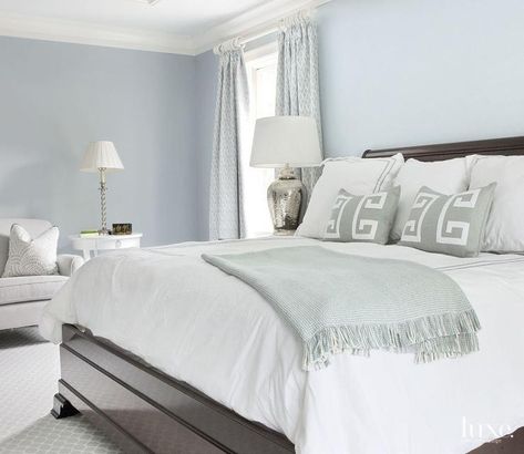 Blue and gray bedroom features blue walls lined with a wood lacquered bed dressed in white and gray pearl beaded duvet and shams, Pottery Barn Pearl Embroidered 280-Thread-Count Duvet Cover & Shams, gray Greek key pillows and a gray knitted throw blanket next to hammered metal bedside lamp placed under window dressed in blue diamond print drapes. Benjamin Moore Windy Sky, Pale Blue Bedrooms, Luxe Bedroom, Summer Bedroom, Decor Color Schemes, Transitional Bedroom, Budget Decorating, Budget Bedroom, Traditional Bedroom Decor