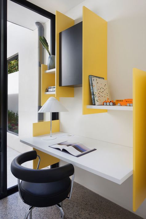 This small and modern study has bright yellow supports that hold the white wall shelves and floating desk in place. Yellow Study, Floating Desk Ideas, Desk And Shelves, White Wall Shelves, Study Table Designs, Modern Study, Study Room Design, Floating Desk, Study Table