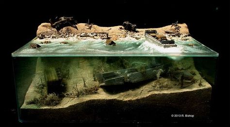 Ramesh Bishop ModelCrafters was commissioned to create a WWII D-Day diorama depicting invasion damage on Normandy Beach both on the beachhead and below the water.  Plexi Diorama shot outside against a dark background   Model Number/Name: Plexi WWII D-Day Diorama, June 6, 1944 • Destruction above and below water Photo Credit: ©️️ 2013 R. Bishop Scale: 1/48 scale, Plexi model overall dimensions: 20” deep x 29” wide x 10” high Mixed Media Photo No. 9908 www.modelcrafters.com Above And Below Water, Normandy Beach, Water Photo, Modeling Techniques, Water Effect, Military Modelling, Model Hobbies, Military Diorama, Miniature Model