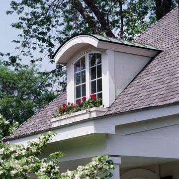 Arched Shed Dormer Window with Copper  The first inclination may be to cover a new dormer top with shingles used elsewhere on the roof, but it's an excellent chance to introduce a new material.  This arched shed dormer window is dressed up with copper roofing material to tie in with hardware found elsewhere on the exterior, and the window box was constructed to match ones gracing windows on the main level. Dormer Window Ideas, Dormer Ideas, Versetta Stone, Exterior Entrance, Dormer Window, Dormer Roof, Shed Dormer, Vinyl Exterior, Copper Roof