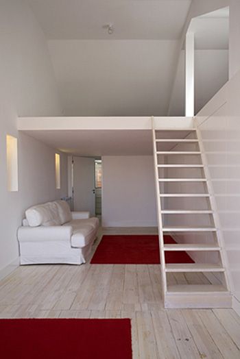 This small apartment has a lot more to it than meets the eye. It may look like just a plain living area, but there are multiple hidden doors for maximum storage and aesthetics. The downstairs features a hidden bathroom and a small living room area. The upstairs has an attic area and a bedroom with plenty of usable space. They used a bright white color for the walls to enhance the light coming in because of the size of the area and it does a great job. Mezzanine Bedroom Ideas, Ikea Small Spaces, Apartemen Studio, Mezzanine Bedroom, Apartment Storage, Small Apartment Interior, Tiny House Loft, Loft Room, Apartment Renovation