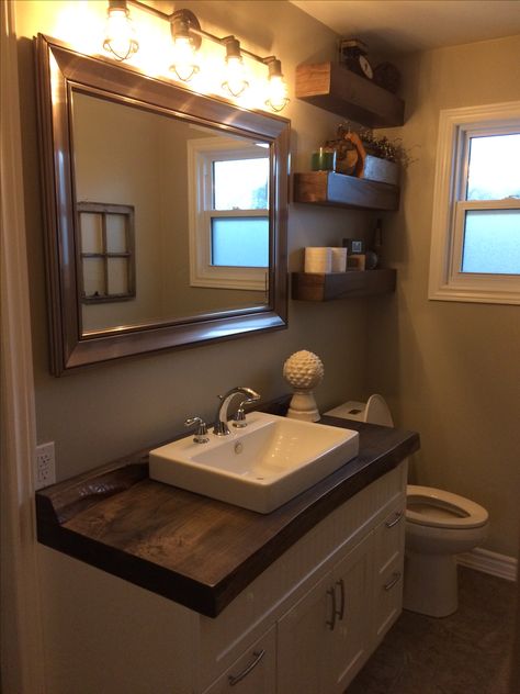 Main bathroom with live-edge wood countertop, tiled floor and homemade floating shelves Live Edge Bathroom Counter, Wood Tile Design, Wood Tiles Design, Hawaii Decor, Easy Backsplash, Faux Wood Tiles, Faux Wood Flooring, Creative Backsplash, Tile Design Ideas