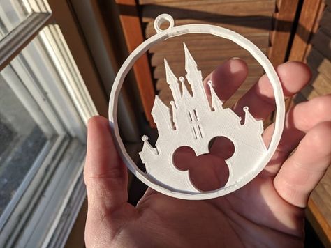 My family took a trip to Disney World a few months back and I wanted something nice to print for them for the holidays. Figured I'd share, because why not? I've successfully printed at .2, but the tiny balls atop the spires and the small openings in the central spire are a bit iffy. Print at .1 if you're worried about those things, but it looks fine otherwise. Edit: I've uploaded a V2 because no matter what I did, my printer was having small issues with the balls on top of the spires as well ... Disney Laser Projects, 3d Print Disney, Disney 3d Printing Ideas, Disney Ornaments Diy, Glowforge Christmas, 3d Printer Art, 3d Tiskárna, Christmas Ornament Template, Trip To Disney World