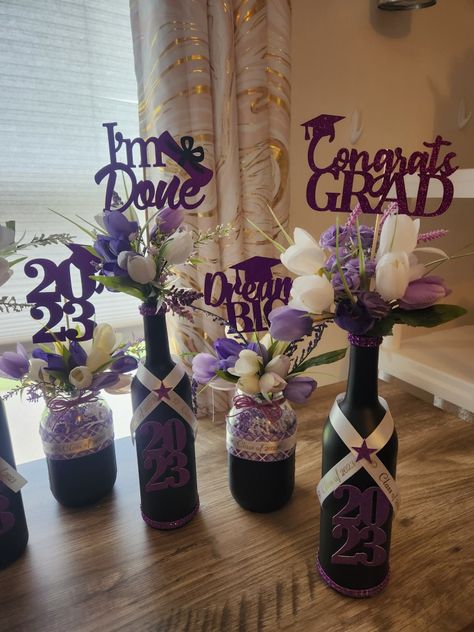 Purple white black flower wine bottle Mason jar Purple And Black Centerpieces Diy, Graduation Bottles Ideas, Purple Black And Silver Graduation Party, Purple Graduation Party Ideas Decoration, Purple Graduation Decorations, Black And Purple Graduation Party Ideas, Purple And White Graduation Party, Purple And Black Graduation Party, Purple And White Party Decorations