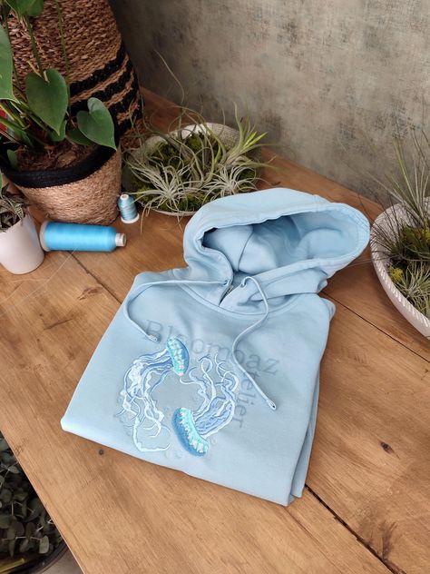 Hey, I'm happy to share my new project with you :)  Water Color Jellyfish Embroidered on Crewneck Sweatshirt, Hoodie Inspired by nature, organic elements and love.  Here's how to wash and take care of your next favorite sweatshirt/hoodie:  1. When to wash the sweatshirt ? I personally don't think that you need to wash it after every use. It needs to be washed after a few wears (five or six).  2. Which washing machine program should you use?  Turn the sweatshirt inside out and use the delicate or hand wash programs to respect the material. Unisex size for adults. Unisex size with variable sizes from XS to 3XL. Enjoy and contact me if you have any questions! Embroidered Jellyfish, Blue Clothes Aesthetic, Aesthetic Christmas List, Hoodie Design Inspiration, Hoodie Inspiration, Stitched Hoodie, Washed Sweatshirt, Embroider Ideas, Hoodie Diy