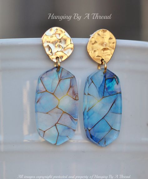 Lovely new earrings made using printed resin charms and hammered gold. The earrings feature irregular shaped gold hammered top, with stud located at upper back. They connected to printed acrylic charms. These have a mosaic style pattern with shades of blue and black, with a shimmery opal feel. Each one has a slightly different pattern, making them unique. Total earring length is 1 7/8". Earrings are 14K gold over brass and are nickel and lead free.  ** Please note - the hammered finish makes the Polymer Clay Jewelry Tutorials, Plastic Earrings, New Earrings, Clay Design, Hammered Gold, Acrylic Charms, Resin Charms, Ceramic Jewelry, Opal Earrings