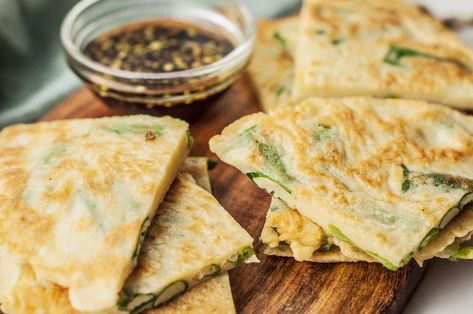 Want to learn how to make Korean pancakes? This scallion pancake recipe (pa jeon or pa jun) is easy to make and is always a big crowd-pleaser. Korean Scallion Pancake, Korean Pancake Recipe, Scallion Pancake Recipe, Scallions Recipes, Easy Korean Recipes, Korean Pancake, Spicy Dipping Sauce, Hearty Snacks, Korean Side Dishes