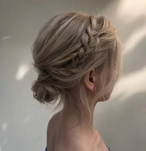 23 Easy Messy Bun Hairstyles You Can Try In Minutes Messy Low Bun Wedding Short Hair, Low Bun With Braid Short Hair, Bridal Low Bun Short Hair, Bridesmaid Side Bun Hairstyles, Formal Low Bun For Short Hair, Messy Low Side Bun Wedding, Tousled Low Bun Wedding, Low Bun With Curtain Bangs Wedding, Low Messy Bun Formal