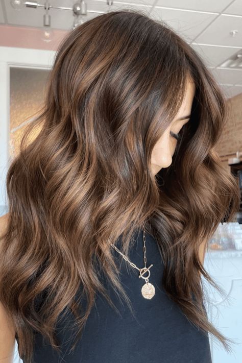 autumn hair colors, brown hair, seasonal hair trends Medium Brown Fall Hair, Warm Walnut Balayage, Iced Coffee Hair Color, Soft Chocolate Brown Hair, Fall Brown Balayage, Cool Vs Warm Brown Hair, Sun Kissed Highlights Brunette, Chocolate And Caramel Hair, Dark Caramel Brown Hair