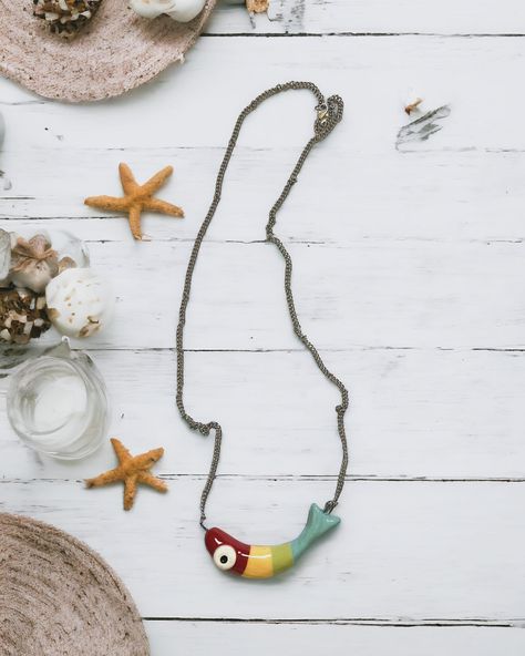 Once upon a time, there existed a vibrant ceramic fish pendant that swayed with charm and color. It dangled playfully, adding a touch of whimsy to the wearer’s world, as if a splash of the ocean’s brilliance was captured in this unique accessory. 🐟🐠🐡🌊 #sealife #sealovers #sealover #seacreatures #fish #fishdecor #fishlover #seadecor #pendant #necklace #ceramicart #ceramics #handmade #madeinitaly Ceramic Necklaces, Clay Fish, Sea Decor, Fish Pendant, Art Decor Diy, Ceramic Fish, Ceramic Necklace, Polymer Crafts, Fishing Decor