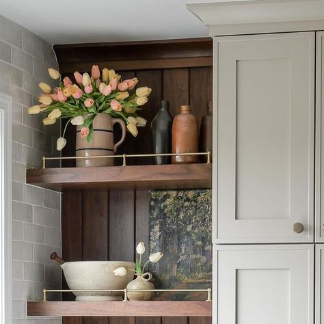 Sarah | Home Design, DIY, Recipes on Instagram: "Build some shelves with me. 😉

Our walnut shelves were the perfect compliment for this corner.

I like to tuck these design details into awkward spaces. This corner would have been very hard to use in a functional way if it were an upper cabinet. And I didn’t want to jeopardize the window spacing or pantry width. So this beauty was born! 

The look was inspired by @cm.interiors and our cabinet maker put their own twist on the back paneling and crown details. 

Do you like adding open shelving in your kitchen? #fromhousetohaven 

Hardware 🤩 is from @amerockhardware and linked in my @shop.ltk (link in bio)

#kitchenremodel #kitchenremodeling #openshelving #openshelvingkitchen #kitchendesignideas #walnutcabinets" Open Corner Shelves Kitchen, Corner Shelves Kitchen Cabinet, Corner Cabinet Ideas Kitchen, Upper Corner Kitchen Cabinet, Corner Shelves Kitchen, 2025 Kitchen, Dining Corner, Upper Cabinet, Corner Kitchen Cabinet