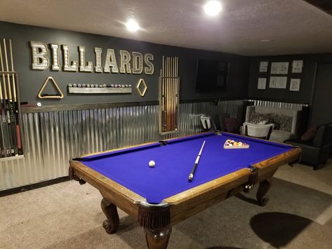 Basement billiards room with lounge areas and a wet bar. Pool table has a purple felt. Garage Billiard Room, Pool Table Entry Room, Basement Billiard Room, Billiard Room Decor Ideas, Pool Table Basement Bar Areas, Basement Game Room Decor, Basement Ideas With Pool Table, Basement Ideas Pool Table, Garage With Pool Table