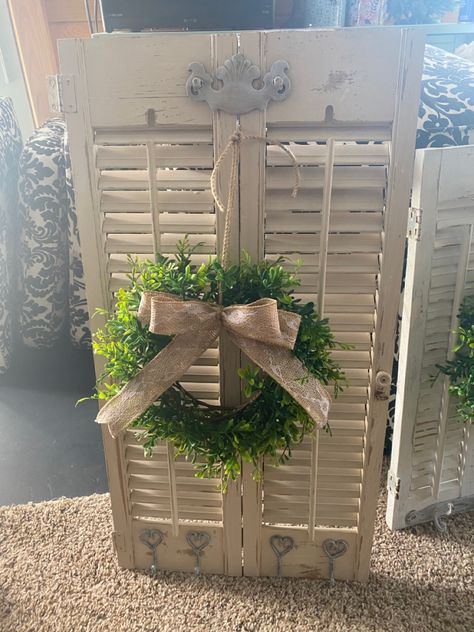 Distressed Shutters with coat hooks and old draw pull for hanging wreath. Decorating With Shutters Inside, Repurposed Shutters Ideas, Repurpose Shutters Projects Diy, Decorating With Old Shutters, Old Shutter Christmas Decor, Christmas Decor Using Old Shutters, Small Shutters Repurposed, Shutter With Wreath Wall Decor, Christmas Shutters