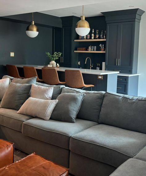 Another moody basement design in the Chimney Retreat project. My client loved the midnight color cabinetry I used in previous basement projects and chose to use it in her own beautiful home bar. The selections are timeless. #basementbar #basementdesign #darkcabinets #timelessdesign #moodydesign Studio Mcgee Basement Bar, Moody Green Basement, Cozy Moody Basement, Dark Blue Basement, Dark Moody Basement Ideas, Dark And Moody Basement, Moody Basement Living Room, All Black Basement, Studio Mcgee Basement