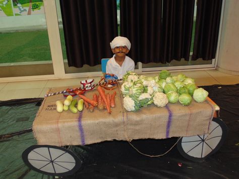 The Nursery and Grade KI and KII students had been recently introduced to different fruits and vegetables. As an extension to our curriculum, the school had organized an event, “Market Day” in the school. A set up of the local market and that of a super market was created. On the day of the event, the students had to get either a fruit or a vegetable. They had also dressed up as buyers or as sellers.The student could identify the different fruits and vegetables and they thoroughly enjoyed. Fruits And Vegetables Dramatic Play, Farmers Market Role Play Eyfs, Fruit And Veg Shop Role Play Eyfs, Indian Food Stall Decor, Fruit And Veg Market, Market Day Ideas, Different Fruits And Vegetables, Curriculum Lesson Plans, Vegetable Stand