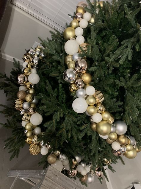 Gold silver ornaments garland  in process Ornament Garland Christmas Tree, Ornaments Garland On Tree, Christmas Ornament Garland For Tree, Christmas Tree Ball Garland, Ball Garland Christmas Tree, Christmas Tree Ornament Garland, Ornament Garland On Tree, Ornament Clusters On Tree, Blue Christmas Tree Decorations