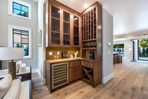 HGTV presents a contemporary wooden dry bar featuring tall glass-door cabinets, a built-in wine rack and a wine refrigerator. Dry Bar Ideas, Tall Cabinets, Basement Home Theater, Basement Layout, Home Bar Design, Game Room Bar, Interior Remodel, Basement Walls, Dry Bar