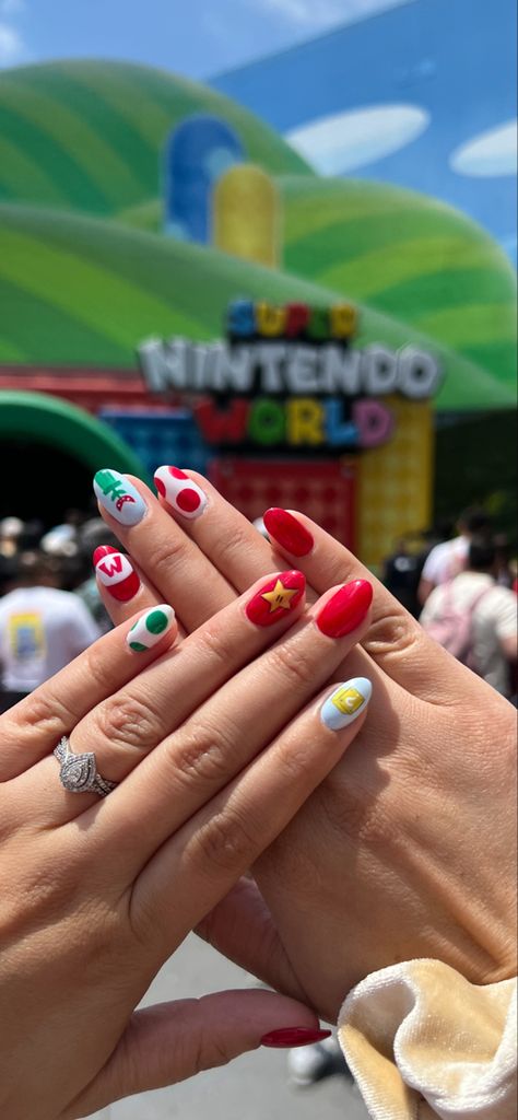 Credit to Raggdoll Nails in Reno, NV - mario themed nails at Super Nintendo World Super Nintendo World Outfit Ideas, Lego Nails Designs, Movie Theme Nails, Luigi Nails, Gamer Nails Design, Super Mario Nails Princess Peach, Mario Themed Nails, Super Mario Bros Nails, Nail Art Themes