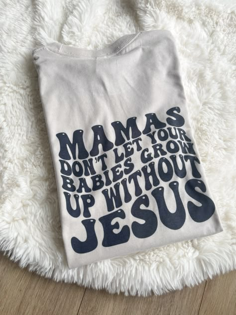 MAMA DON'T LET YOUR BABIES GROW UP WITHOUT JESUS UNISEX FIT PRINTED ON HEATHER DUST WITH BLACK INK BACK: LARGE PRINT, FRONT: SMALL POCKET PRINT BRAND: BELLA AND CANVAS Christian Cricut Shirts, Cute Mama Shirts, Cute Custom Shirts, Cricut Mom Gifts, Mom And Baby Shirts, Jesus Tshirt Design, Mama Sayings For Shirts, Mama Shirt Ideas, Jeses Shirts