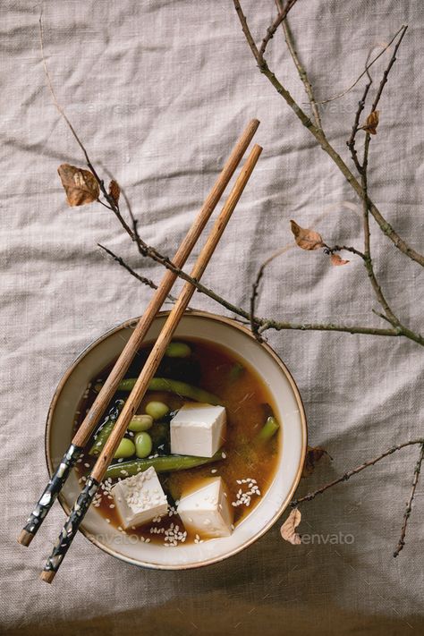 Tofu miso soup by NatashaBreen. Japanese Miso broth soup with silk tofu cubes, soy beans edamame, green beans in ceramic bowl with chopsticks on grey... #AD #broth, #Miso, #tofu, #silk Silk Tofu, Tofu Miso Soup, Miso Tofu, Tofu Cubes, Miso Broth, Broth Soup, Asian Dinners, Soy Beans, Miso Soup