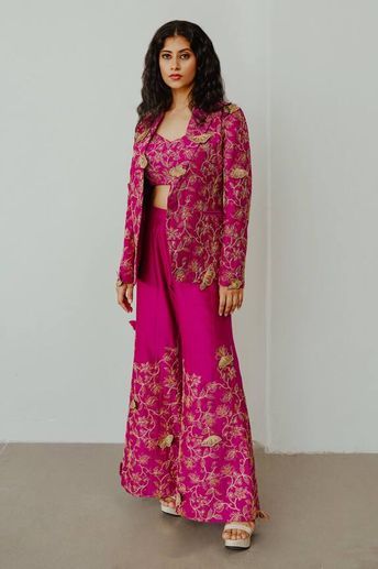 Magenta chanderi jacket with 3D butterfly motifs, dori and resham embroidery. Comes with flared pant and a bustier.
Components: 3
Pattern: Embroidered
Type Of Work: Butterfly motifs. Dori, Resham
Neckline: Jacket : Lapel collar, Bustier : Sweetheart
Sleeve Type: Jacket : Full, Bustier : Sleeveless
Fabric: Chanderi
Color: Magenta
Other Details: 
Closure : Jacket - Front button
Note : Black outfit worn by the other model is not for sale.
Occasion: Party,Cocktail - Aza Fashions Magenta Butterfly, Shrug Outfit, Resham Embroidery, Trendy Outfits Indian, Recycled Dress, Lehenga Designs Simple, Latest Dress Design, Traditional Indian Outfits, Dress Design Patterns