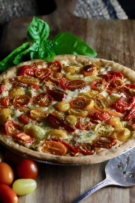 Filled with tomato deliciousness through and through, this mouth-watering Cherry Tomato Pie is perfect for a summer brunch, lunch, or even a light dinner paired with a fresh vegetable salad. Full of sunshine and vitamin C, roasted cherry tomatoes are the essence of this recipe. I like to use multicolored tomatoes, but you can use whatever kind you have on hand. Grape tomatoes also work. #cherrytomatoes, #tomatorecipes, #tomatopie Cherry Tomato Pie Recipe, Tomato Pie With Cherry Tomatoes, Cherry Tomato Pie, Cherry Tomato Tart, Fresh Vegetable Salad, Tomato Pie Recipe, Fresh Tomato Recipes, Savory Pies, Tomato Pasta Sauce