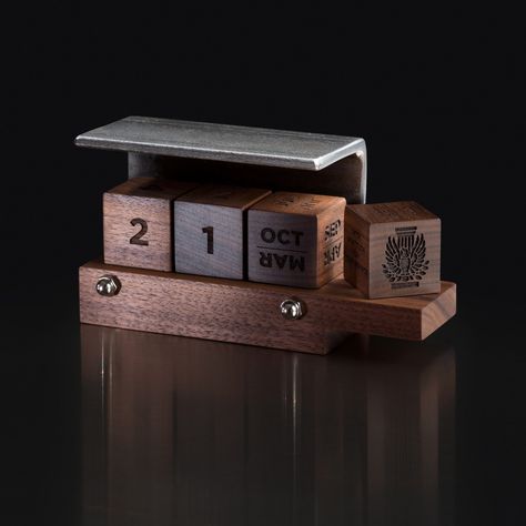 Designed with a steel angle typically found in construction, our perpetual calendar has quickly become a favorite business gift. Three wood cubes perpetually denote days and months and changing them makes for a perfect little daily habit. A fourth cube is added to personalize the piece with your organization’s logo and encouraging or congratulatory phrases. Steel & Walnut & Function & Play! Corporate Christmas Gifts, Trophy Design, Executive Gifts, Learn Calligraphy, Company Gifts, Calendar Gifts, Office Items, Diwali Gifts, Business Gift