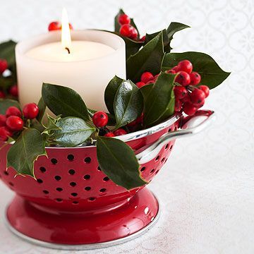 Christmas Colander  Make a charming table centerpiece with a colorful colander. Fill it with holiday greenery such as ivy leaves and berries. Insert a glass candleholder in the center and add a white unscented candle. Use a small colander to accent a cocktail table and a larger one for a dining table. Natal Country, Holiday Greenery, Christmas Kitchen Decor, Birdcages, Muffin Tins, Spatulas, Noel Christmas, Christmas Kitchen, Christmas Centerpieces