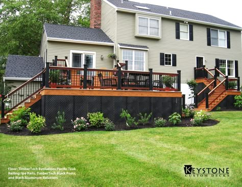 This Custom TimberTech Evolution Pacific Teak decking with Ipe Rails, TimberTech Black Posts, and Round Black Aluminum Balusters. This Deck also features Black Lattice around the bottom of the deck. Built by Keystone Custom Decks. Deck Skirting Ideas, Skirting Ideas, Black Pergola, Deck Landscaping, Deck Skirting, Steel Pergola, Building A Porch, Pergola Attached To House, Pergola Design