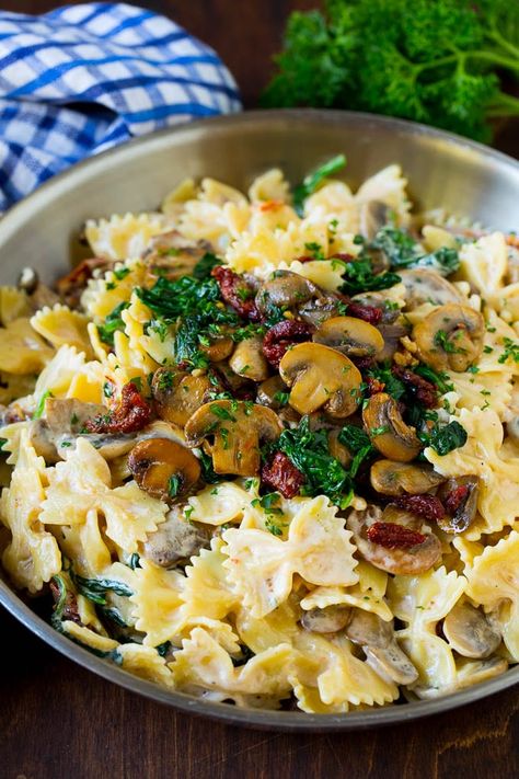 This farfalle pasta recipe is a Tuscan style blend of sun dried tomatoes, spinach and mushrooms, all tossed with noodles in a creamy parmesan sauce. Mushroom Farfalle Pasta, Recipes With Farfalle Pasta, Pasta With Mushrooms And Tomatoes, Chicken Farfalle Pasta Recipes, Pasta With Sun Dried Tomatoes Recipes, Pasta With Mushrooms And Spinach, Farfalle Pasta Recipes, Farfalle Recipes, Pasta Farfalle