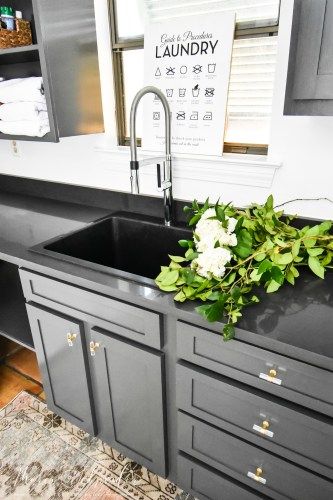 A laundry room sink, also called a utility sink or laundry sink, can be a major convenience if you have the space for one in your home. Read on to see the laundry room sink I chose for our new laundry room and why I love it! #laundryroom #laundryroomsink #utilitysink #utilityroom #laundry #wayfair #blanco #blacksink Utility Sink With Counter, Black Utility Sink In Laundry Room, Laundry Sinks Utility, Utility Sink Faucet, Farm Sink Laundry Room, Built In Utility Sink, Laundry Room Faucets Utility Sink, Deep Laundry Sink, Laundry Room Black Countertops