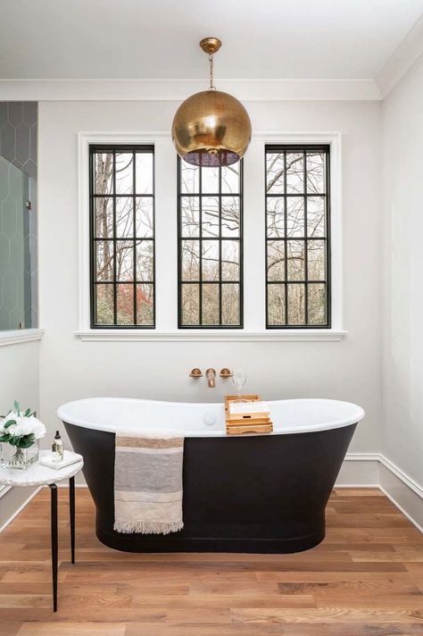 This triple gable European Tudor home designed by Frusterio Design and Pike Properties is located in Charlotte, North Carolina. Black Vanities, Plank And Pillow, Black Tub, Bathroom Window Treatments, All White Room, Bathroom Window, Perfect Bathroom, Primary Bath, Bedroom Essentials