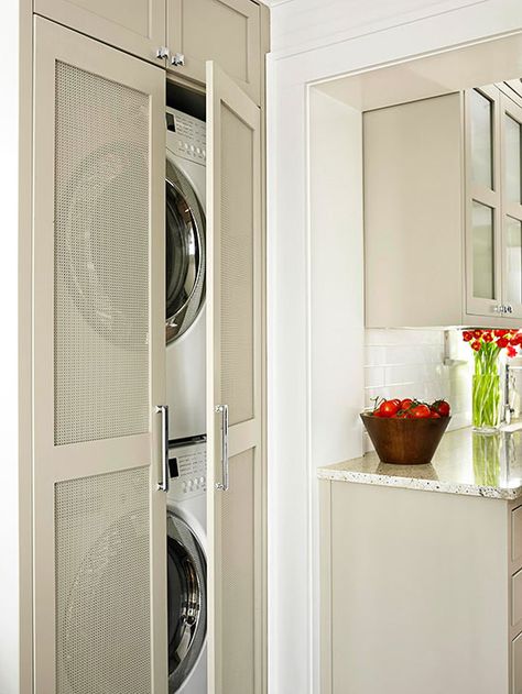 Small-Space Laundry Closet A full-size laundry room might not be an option for some condos, apartments, and small homes. This stacked washer and dryer tucks away in a slim closet off of the kitchen and uses nearby cabinets for storage. Perforated door panels add visual interest and ventilate the laundry area while keeping the appliances out of sight. Laundry Room Storage Solutions, Laundry Storage Solutions, Laundry Room Storage Shelves, Small Laundry Room Organization, Laundry Room Doors, Laundry Closet, Laundry Decor, Small Laundry Rooms, Small Laundry Room