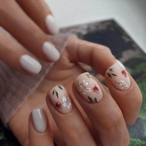 Bridal manis with pearl-studded embellishments, rhinestone swirls, colorful abstract patterns and floral motifs are giving us some major inspiration for wedding day nail art! These are 36 of our favorite modern nail designs we have seen yet. Short Gel Nails Floral, Short Nails Floral Design, Neutral Floral Nails Short, Bridal Nails Flowers, Bridal Nails With Color, Blush Floral Nails, Nails With Greenery Design, Spring Russian Manicure, Bridal Nails Boho