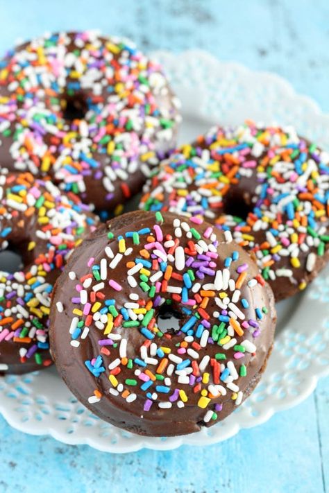 Four chocolate frosted donuts on a white dessert plate. Each donut is coated in sprinkles. Vegan Entertaining, Doughnuts Baked, Donuts With Sprinkles, Vegan Doughnuts, Baked Donut Recipes, Dessert Board, Vegan Breakfasts, Gluten Free Chocolate Cake, Vegan Party