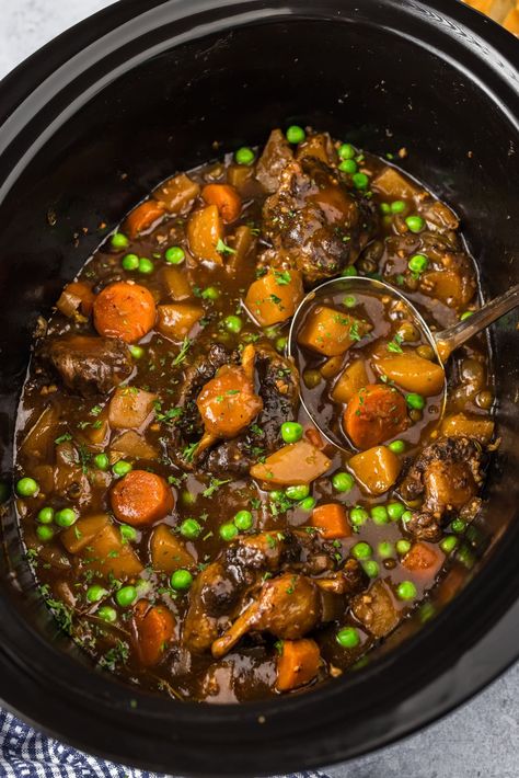 Tender slow cooker oxtail with carrots, peas, and potatoes smothered in rich gravy is hands down one of the easiest ways to prepare the best oxtail stew! Oxtail Slow Cooker, Slow Cooker Oxtail, Oxtail Stew, Crockpot Mac And Cheese, Mexican Chicken Casserole, Blueberry Breakfast Cake, Low Carb Appetizers, Quick Easy Desserts, Chocolate Peanut Butter Cookies